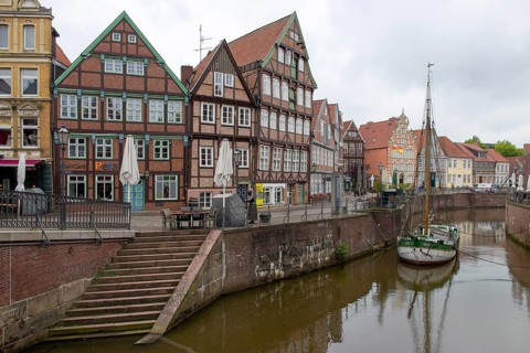 Medieval houses on the canal in Stade, and museum sailing ship Willi, Hanseatic harbour, fish