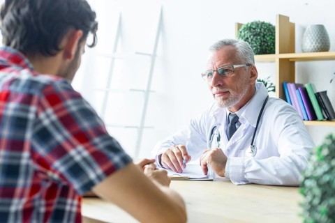 Senior doctor listening patient closely