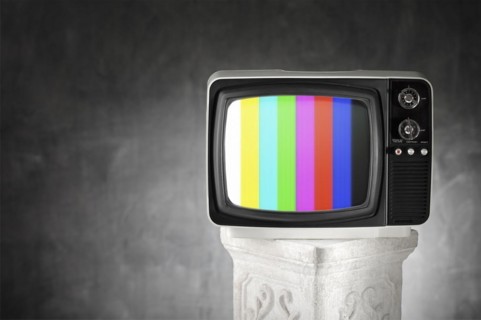 Old television with color bars on a plaster column