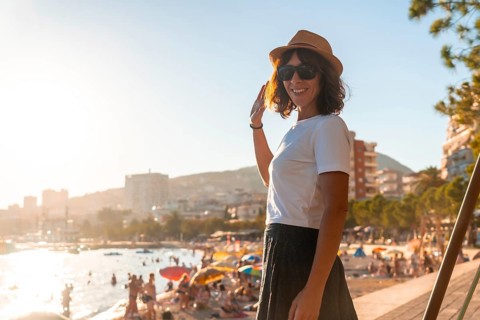 A tourist woman at sunset in Sarande or Saranda on the Albanian riviera, Albania, Europe