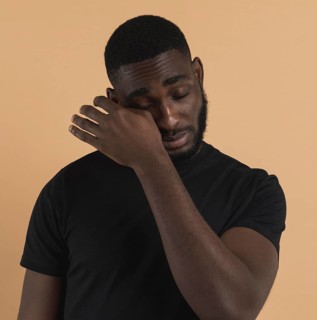 Person wiping away his tears