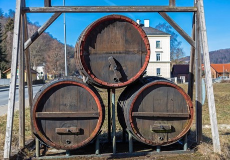 Three large old beer barrels on a road in Bavaria
