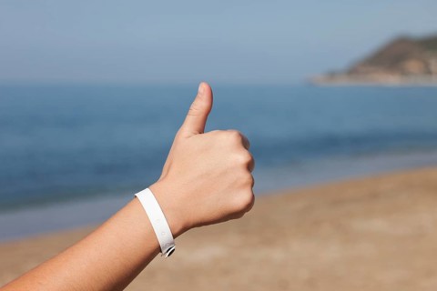 Summer vacations, woman hand gesturing thumb up success sign on sea sand beach