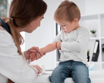 Adorable baby waiting be checked by doctor