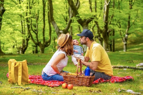 A picnic day with your newborn son. Dressed in white and yellow t-shirt, summer lifestyle of a