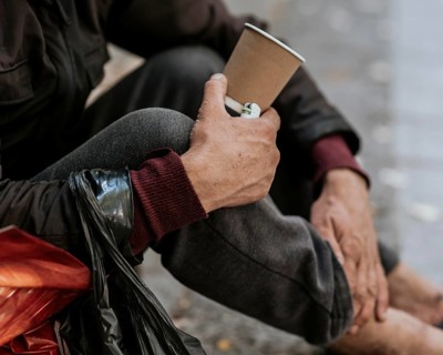 Side view homeless man holding cup