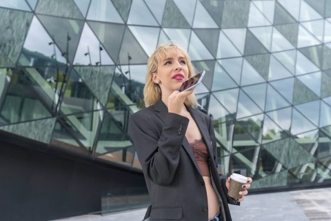 Entrepreneurial girl business park in a modern building with colored glass, young blonde woman in