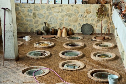 Wine cellar with traditional large earthenware vessels buried in the ground, Qvevri, Kvevri, in