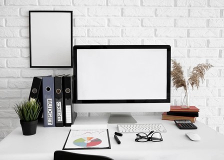 Front view office desk with computer screen glasses