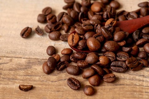 Close up roasted coffee beans with spoon