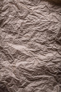 Ancient messy crumpled paper in vertical design