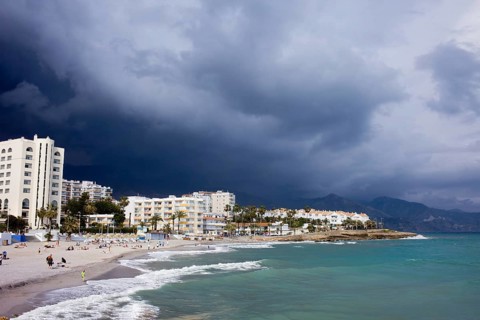 Apartment houses along Costa del Sol sandy beach in resort town of Nerja at the Mediterranean Sea