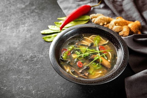 Asian vegetable soup with noodles, mushrooms, sugar peas, nori, ginger and chili, traditionally