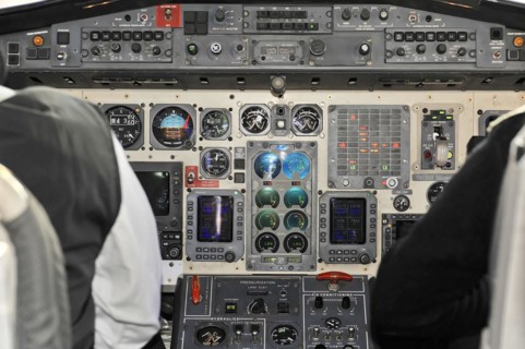 Close-up of a cockpit instrument panel with switches and screens, impressions of the great