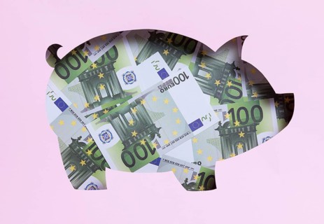 Stack euro notes inside piggy bank