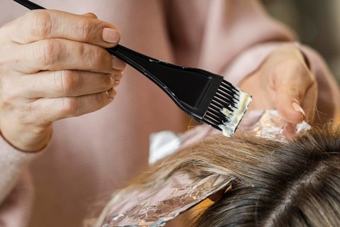 Woman getting her hair dyed home by beautician. Beautiful photo