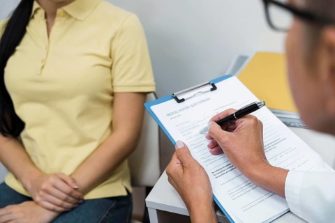 High angle doctor consulting patient her office