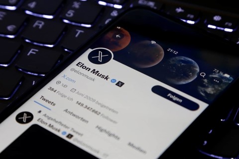 Symbolic image social media, close-up of a smartphone on illuminated computer keyboard with X logo
