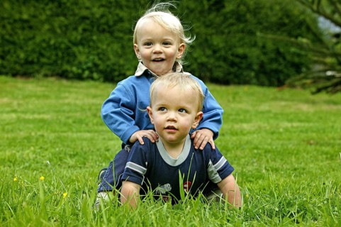 TWIN BROTHERS PLAYING ON GRASS