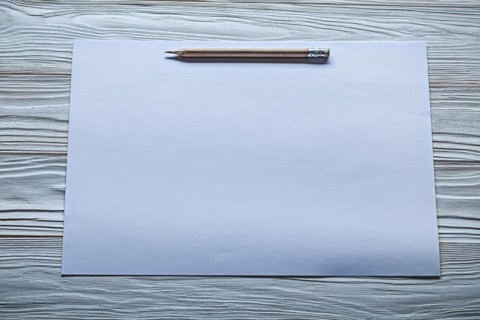 White paper with pencil marks on old wooden panels