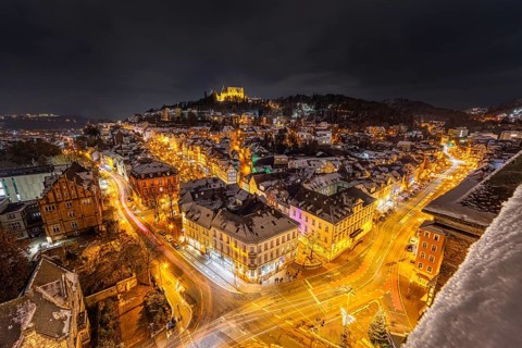 The lights of the snow-covered town of Marburg an der Lahn glow in the evening, Wetterau, Marburg,