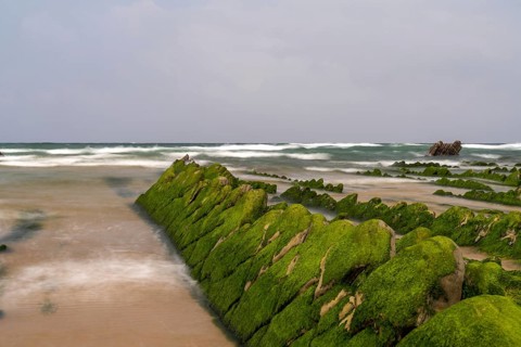 A long exposure view of Flysch rock formations at low tide at Barrika beach near Bilbao