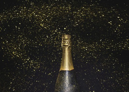 Bottle champagne flying golden glitters