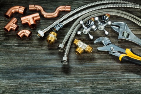 Chrome and copper plumbing accessories on vintage wood