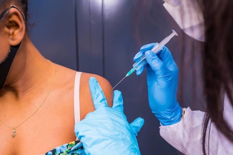 Detail of the vaccination in a black African ethnic girl, immunizes the population, people at risk,