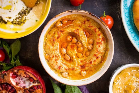 Hummus plate close-up. Hummus, tahini, pitta and buttermilk dip with olive oil. Most famous dishes
