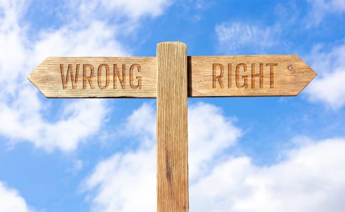 Wrong or right concept. Wooden signpost with message on sky background