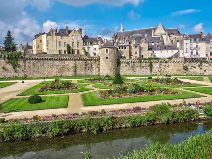 The city walls with the Tour Poudrière tower and the old town in the background. In front of the