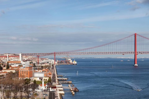 City of Lisbon in Portugal, promenade along Tagus river and 25 de Abril Bridge