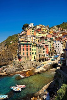Photo of the colorful houses of the fishing port of Riomaggiore, Cinque Terre National Park,