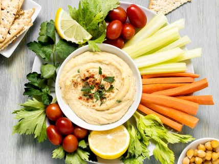 Top view hummus with assortment vegetables. Beautiful photo