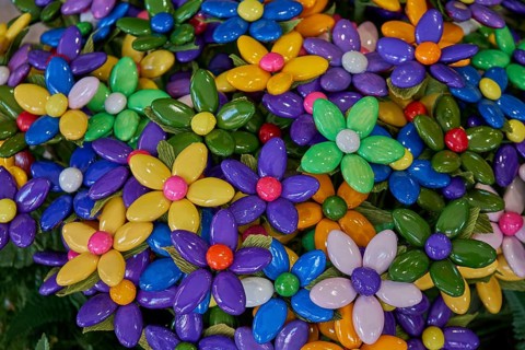 Colourful flowers made of confetti, shiny caramelised almonds, traditional sweet from Sulmona,