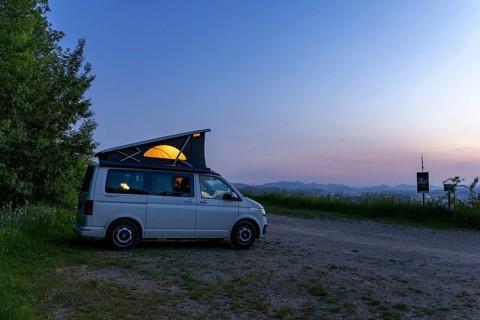 Camping with VW Bus T6.1 California, with pop-up roof and soft light, in hilly landscape, Oltingen,