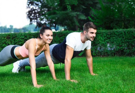 Young happpy couple exercising and stretching muscles before sport activity