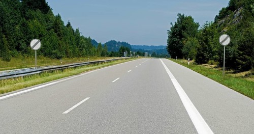 Empty Autobahn, freeway, with german traffic signs meaning speed limit cancelled, A 95 near