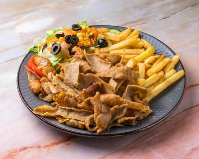 Chicken Shawarma plate with salad, fries served in a dish isolated on grey background side view of