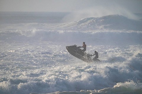 Jet ski jumping over a wave in the stormy Atlantic Ocean, Nazaré, Portugal, Europe