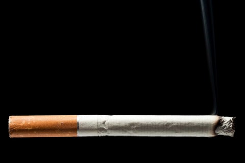 Addiction issue, smoking cigarette black isolated