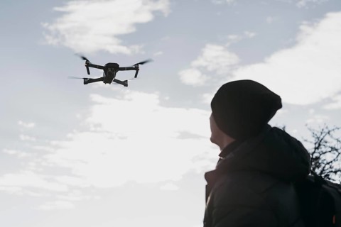 Low angle man watching drone