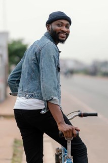 Medium shot man with bicycle posing