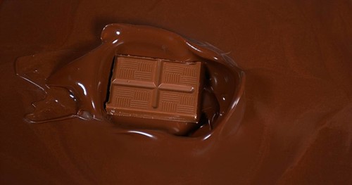 Chocolate tablet falling into Milk Chocolate