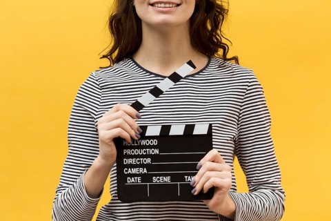 Woman director holding clapperboard