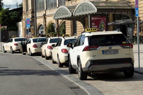 Taxis parked at a taxi rank in front of Dammtor train station in Hamburg, Germany, Europe