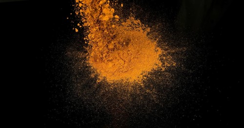 Turmeric (curcuma longa), Powder Exploding against Black Background, Indian Spice