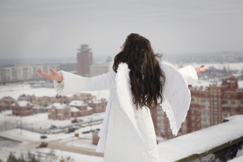 Angel on the roof in cold winter