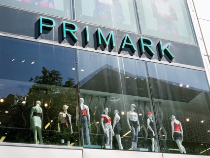 Hannover, Germany - May 7, 2018: Primark logo sign on storefront above shop window mannequins